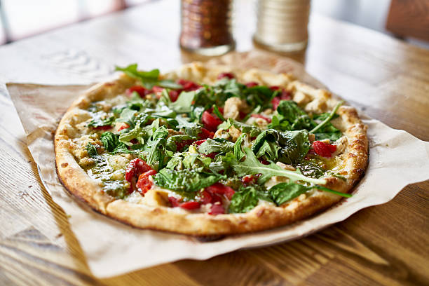 istock fresh brick oven fired pizza on table top in restaurant 629253876