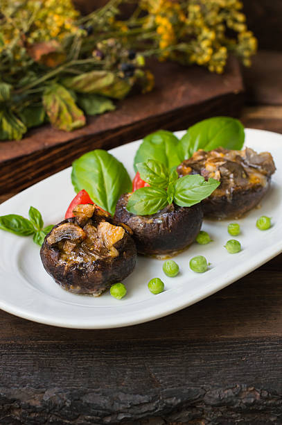 istock Stuffed champignon quail eggs with basil and tomatoes. Wooden background 629254992