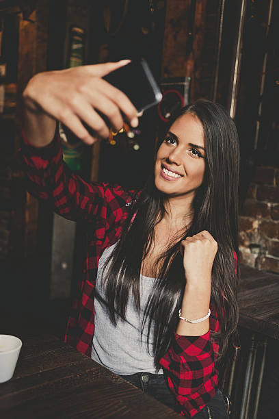 istock Young woman taking selfie in cafe 629256842