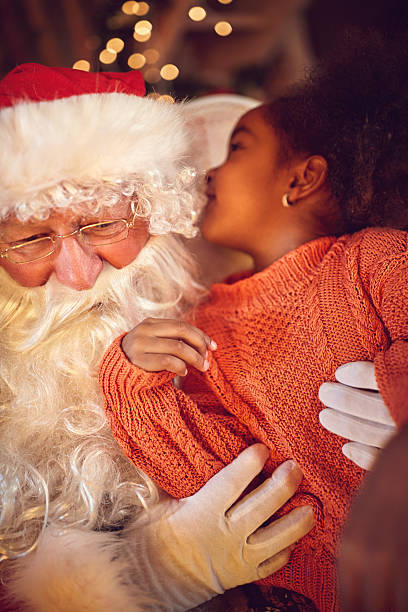 istock Child whispers something to Santa Clause 629256892