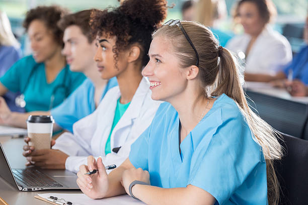 istock Attentive female nursing or medical student takes notes in class 629257328