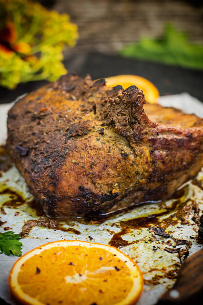 istock Baked pork ribs with sauce and basil on a black 629264976