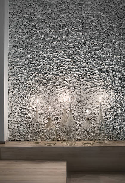 istock Stylish candlesticks on pebble wall background 629268260