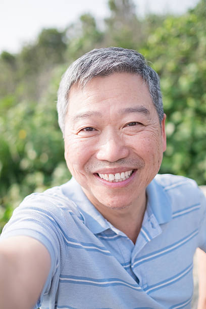 istock old man smile and selfie 629269220