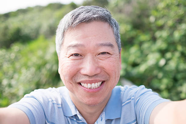 istock old man smile and selfie 629273606