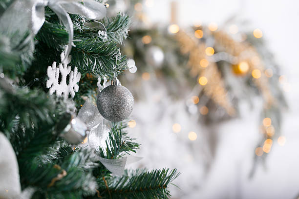 istock light from the garlands. Christmas tree decorated ball close-up. 629274146