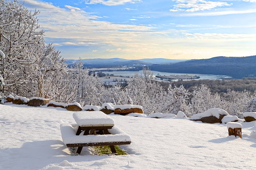Sunrise on a snow covered mountain with a picnic table in the forground. Lancaster County, Pennsylvania, USA.