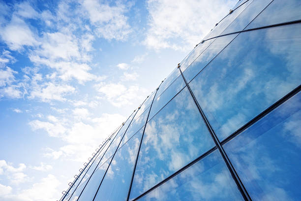 istock Clouds reflected in windows of modern office building 629278644