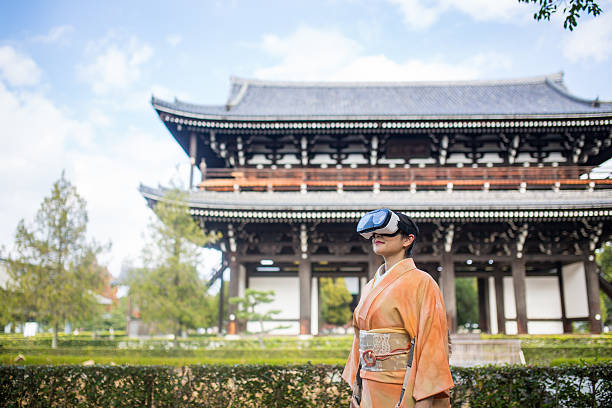 Woman in virtual reality headset surrounded by Japanese scenery stock photo