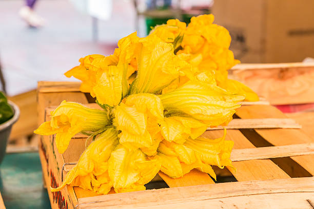 istock Courgette or zucchini flowers at the market 629285612