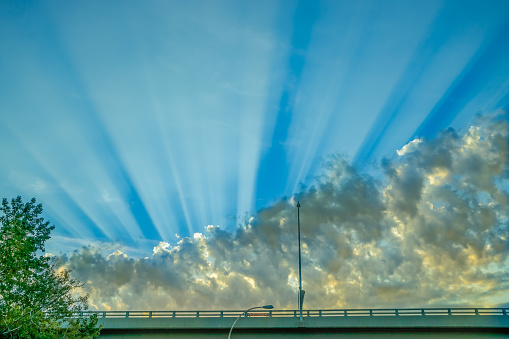 Clouds with sun ray behind the bridge deck in early morning hours