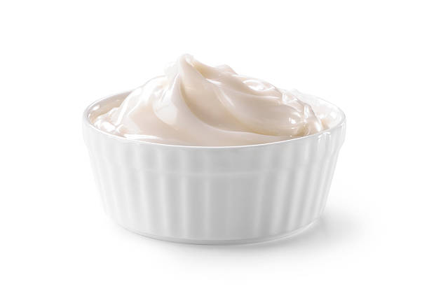 bowl of whipped cream close-up isolated on white
