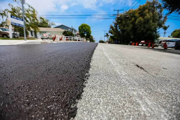 new asphalt covering on a residential street