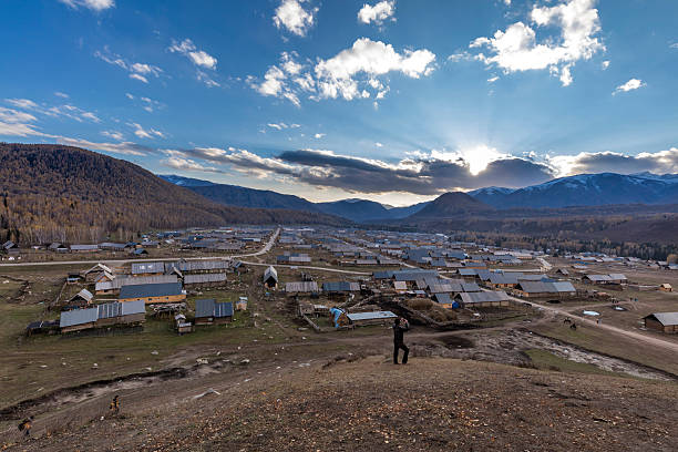 Hemu, Xinjiang, China - October 6, 2016: Autumn sunset time view of the Hemu Villiage. The main road pass though the villiage. Hight angle view, Incidenetal poeple on the background.