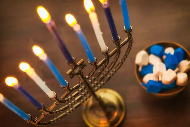 Menorah with burning candles and dreidel. Hanukkah preparations