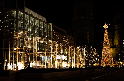Kurfurstendamm street in Western Berlin with Christmas tree, illumination and decoration and tall Berlin letters at night