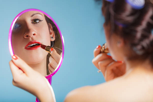 istock Girl applying make up red lipstick 629295264