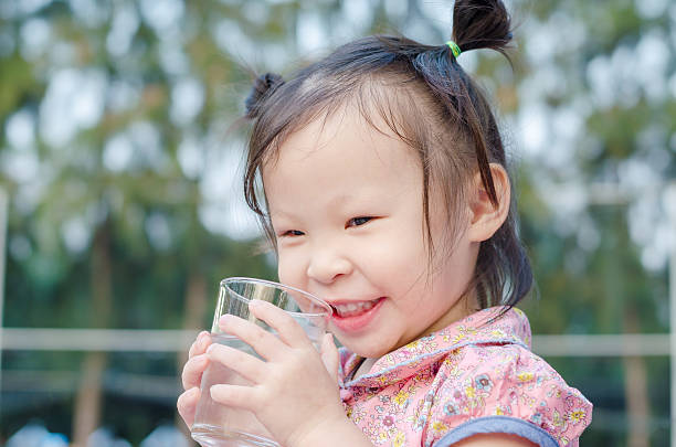 istock girl smiles after drinking water 629295674