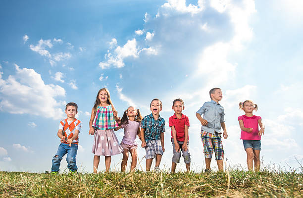 istock Group of playful children having fun in a meadow. 629295862