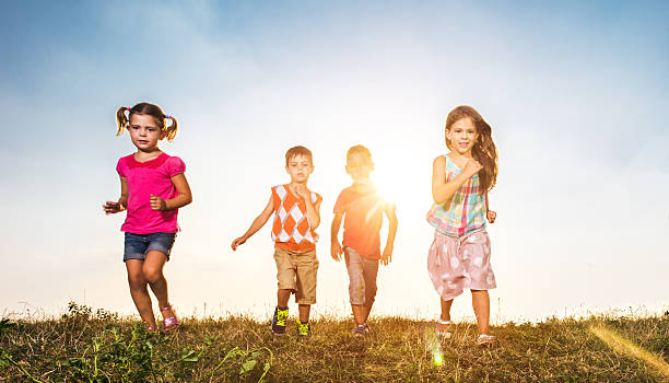 istock Little children running in a meadow at sunset. 629296776