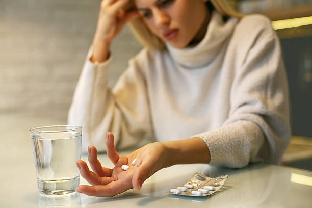 Pills in woman hands. stock photo
