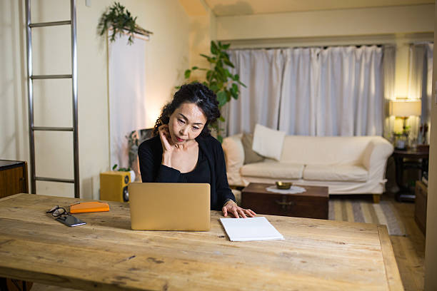 Mature woman working from home stock photo