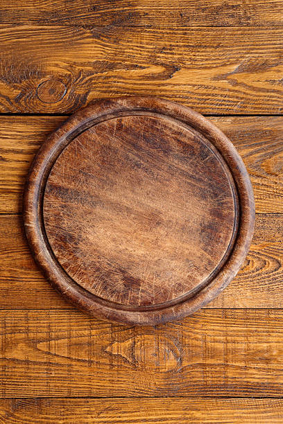 istock Wooden round board for pizza 629306058