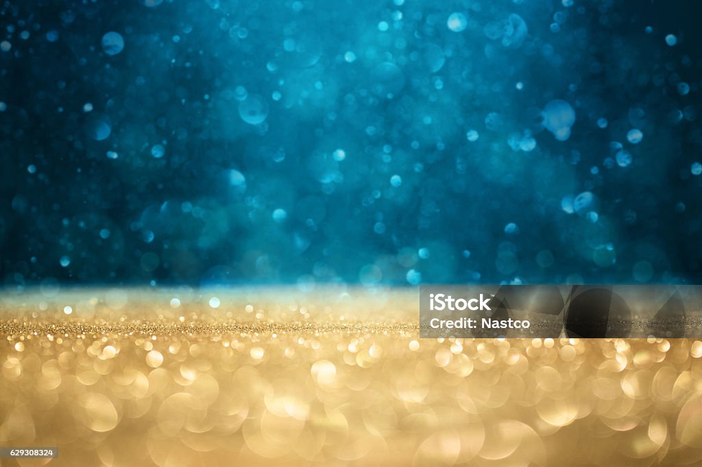 Defocused glitter background Abstract defocused gold and blue glitter background with copy space Celebration Stock Photo