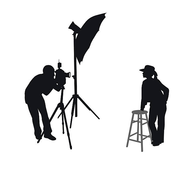 Cowgirl Photo Shoot Silhouette Vector A vector silhouette illustration of a photographer taking pictures of a young girl dressed as a cowboy. country fashion stock illustrations