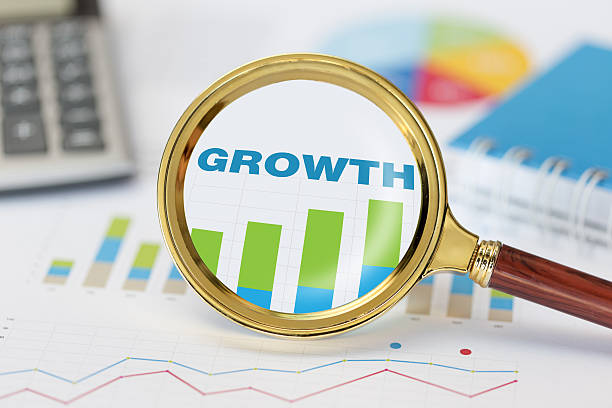 istock Magnifying glass and calculator on growth graph 629322272
