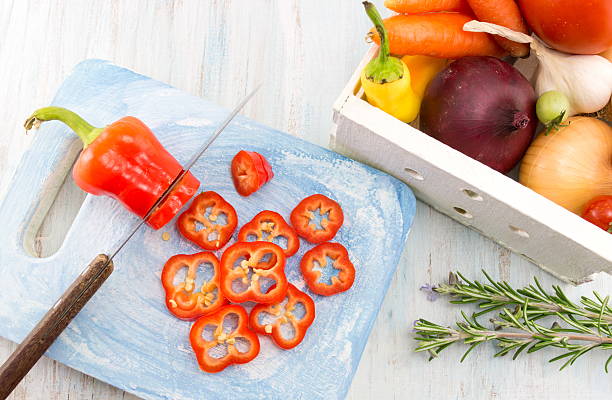 istock Cutting red pepper on a wooden tray 629322644