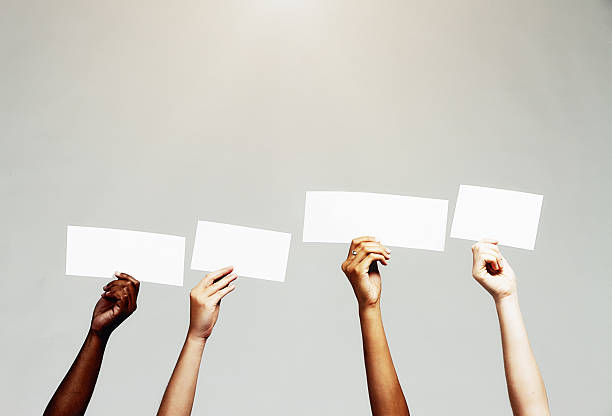 istock Four blank signs held up,  ready for your message 629323246