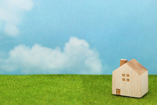 istock House on green grass over blue sky and clouds. 629323762
