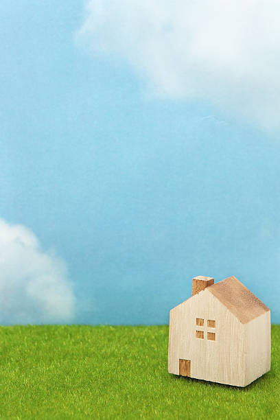 istock House on green grass over blue sky and clouds. 629323852