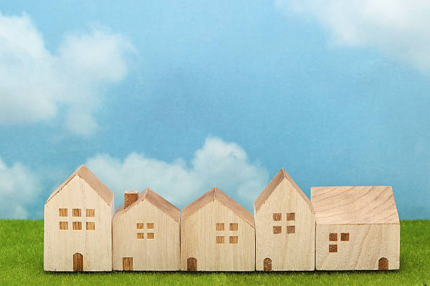 istock Houses on green grass over blue sky and clouds. 629323956