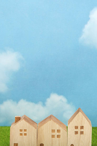 istock Houses on green grass over blue sky and clouds. 629324026