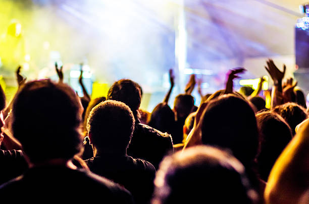 istock concert ray light hands up people music bokeh band head 629339122
