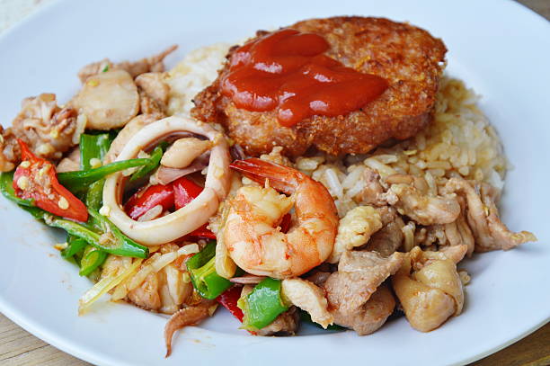 stir fried mixed seafood with sweet long chili and deep fried pork on rice