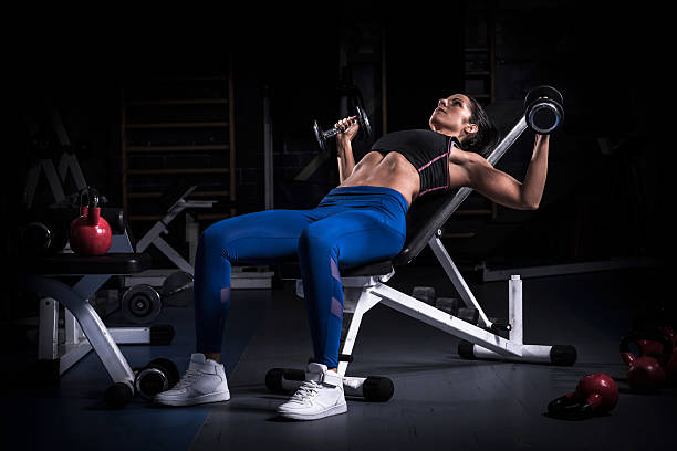 point of view asian female workout with dumbbell kickback at gym - for fitness and bodybuilding