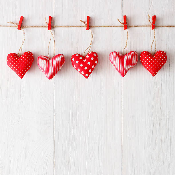 istock Valentine day background, pillow hearts border on wood, copy space 629353788