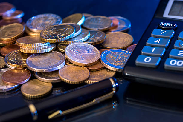 istock euro coin and banknotes with calculator, pen  isolated on 629354786