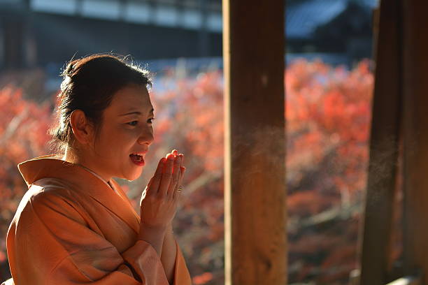 Japanese woman in kimono breathing white at Tofuku-ji Temple stock photo