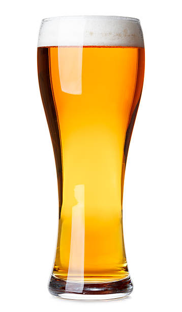 Tall glass of pilsner beer with head isolated Full pilsner glass of pale lager beer with a head of foam isolated on white background pilsen stock pictures, royalty-free photos & images