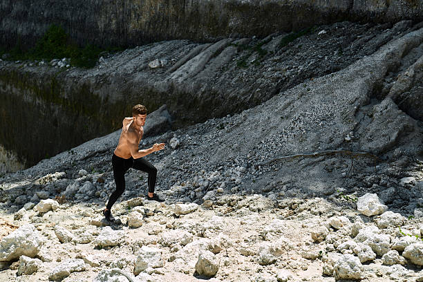 istock Man Running Up Rocky Hill, Exercising During Outdoor Workout. Sp 629356758