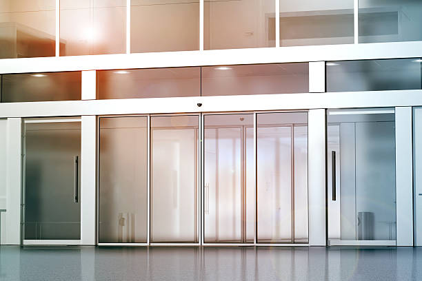 Blank sliding glass doors entrance mockup Blank sliding glass doors entrance mockup, 3d rendering. Commercial building entry mock up. Office exterior outdoor template. Emporium facade on sunset, front view. Sunny shopping center. automatic stock pictures, royalty-free photos & images