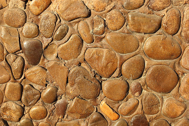 istock yellow pebble stones on a wall abstract texture background 629357360