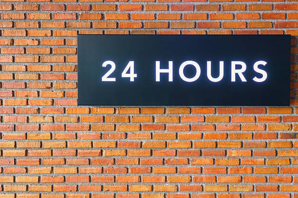 istock Twenty four hours glowing sign on  brick wall 629357932