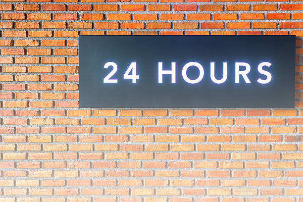 istock Twenty four hours glowing sign on  brick wall 629364498