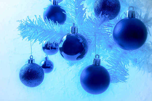 istock White Christmas tree branch with blue ornaments 629364744
