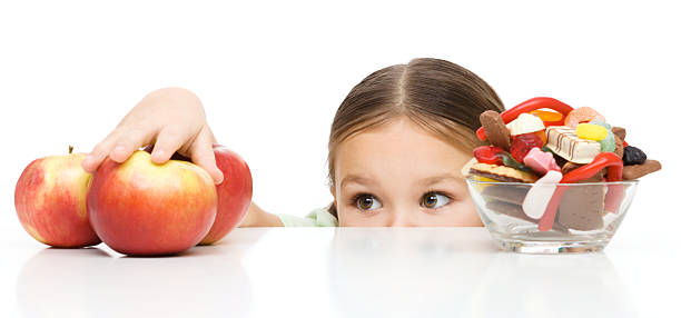 Little girl is reaching apple stock photo